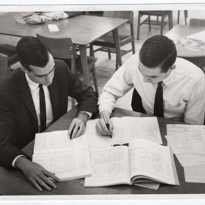 Two Business Administration students working at desk in Drexel Library, c. 1965.
