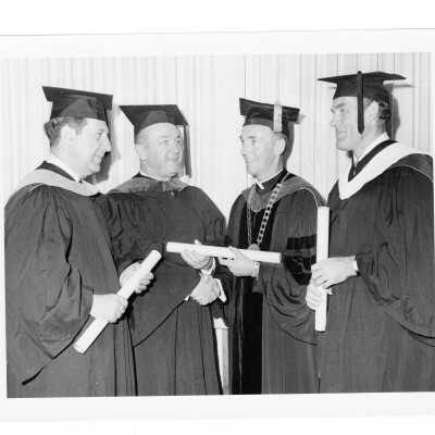 Terrence Toland, S.J., with three honorary degree recipients, Fred Hechinger, William T. Cahill, and Louis C. Fischer during 1970 graduation/commencement.