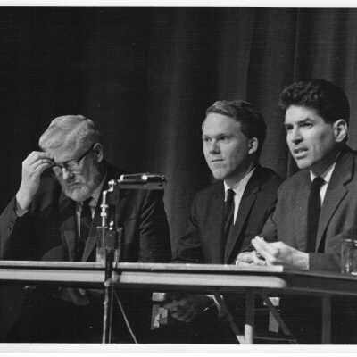 James E. Dougherty, David Marshall, and Fred J. Foley, Jr. participating on panel debating the Vietnam War before an audience of 400 students and faculty.