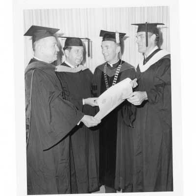 Terrence Toland, S.J., with three honorary degree recipients, Fred Hechinger, William T. Cahill, and Louis C. Fischer during 1970 graduation/commencement.