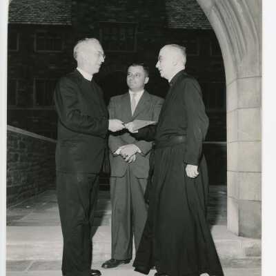 J. Joseph Bluett, S.J., (President), Joseph S. Hogan, S.J., and Carmen Casciato with ceremonial trowel in Barbelin archway.