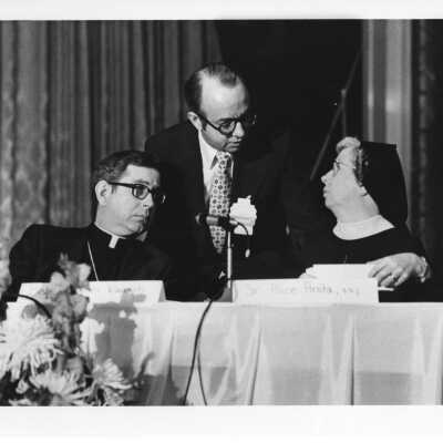 Dr. Thomas Melady speaking to panel members, Bishop James Rausch and Sister Alice Anita, at International Eucharistic Congress, symposium on hunger, August 2, 1976, held at Philadelphia Civic Center.
