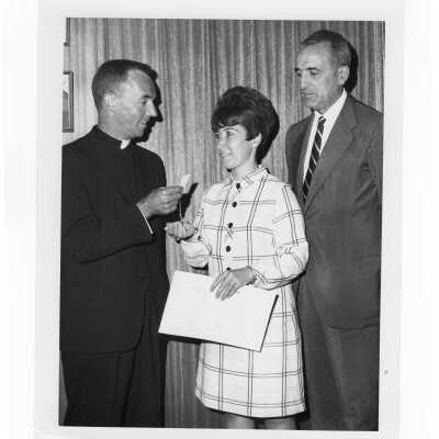 Pax Romana's 20th World Plenary Assembly meets at Saint Joseph's College, August, 1968. Terrence Toland, S.J. presents key to ghetto building to Mrs. Maria Cruz, Acting President of OPEN, while Dr. Joaquin Ruiz-Gimenez, President of Pax Romana, looks on.