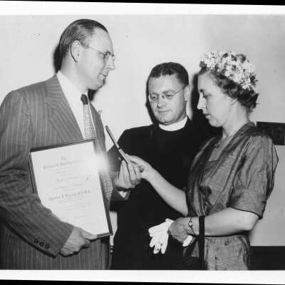 Dr. Charles P. Bailey showing Shaffrey award medal to Edward G. Jacklin, S.J., and his wife, June 3, 1951.
