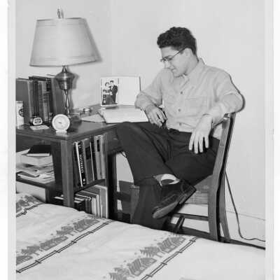 Student resident of Quirk Hall studying in dormitory room.