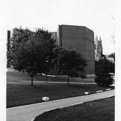 Exterior view of science center with Drexel Library and Barbelin Tower in far background.