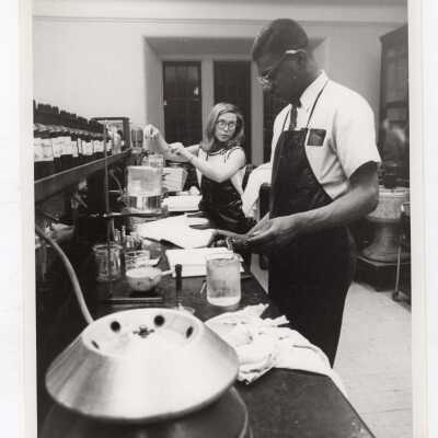 Two graduate chemistry students working in science laboratory, c. 1965.