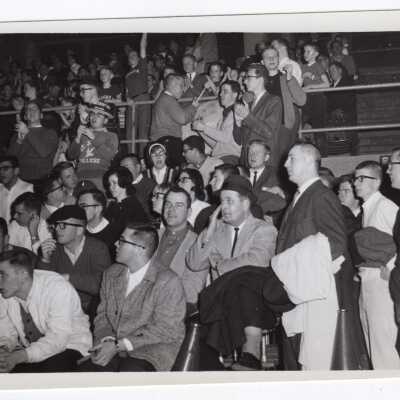 Men's Basketball, student crowd watching game.