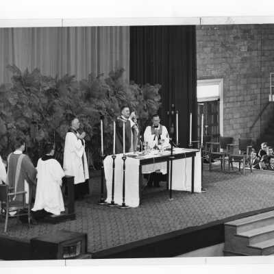 William F. Maloney at elevation of bread and wine during Mass of the Holy Spirit in Field House, October 8, 1963.
