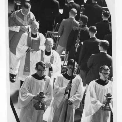 Recessional after Mass of the Holy Spirit in Field House, c. 1962 with William F. Maloney, S.J., Michael Smith, S.J., and Matthew Quinn, S.J.