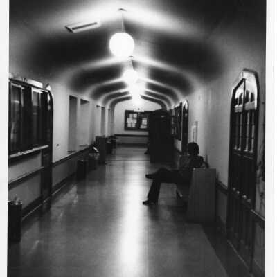 Interior view of hallway in Barbelin with student sitting on bench.
