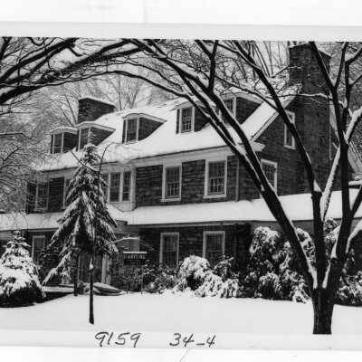 View of front of Saint Albert's Hall in the snow.