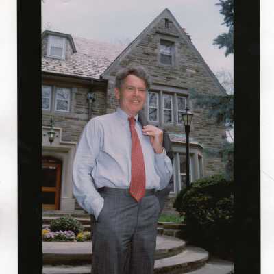 Michael J. Morris (Board of Trustees) standing in front of Regis Hall.