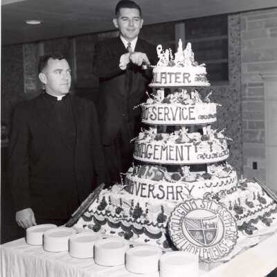 Dedication of Campion and cafeteria. William F. Deal of Slater Food Service and Paul F. X. Leary, S.J. at cake-cutting.