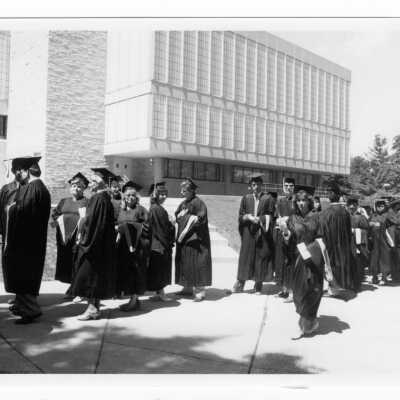 Graduates processing by Drexel Library and Science Center during graduation/commencement, c. 1985.