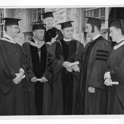 Edward G. Jacklin, S.J. with Charles W. Perelle, James C. Ganey, Francis C. Nash, Francis Dieter, and John Molloy at 1952 graduation/commencement. (Four black and white prints.)