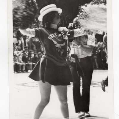 Woman cheerleader at basketball game.