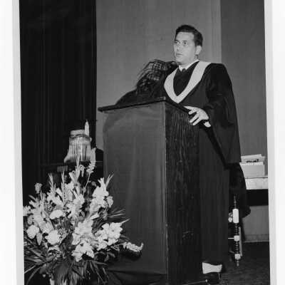 Tropaia exercises during 1955 graduation/commencement with Alumni President, W. Ariano giving alumni induction at podium.