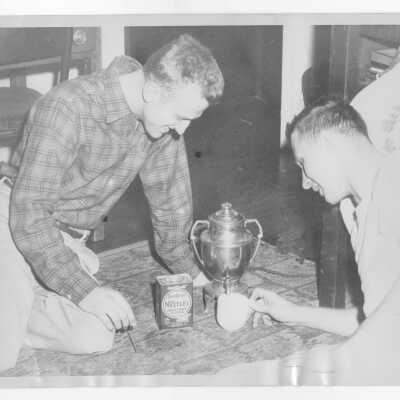Two students from Barry Hall making Nestle's instant cocoa using electric urn with spigot.