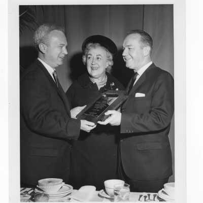 Kathryn Granahan looking at Hogan Alumni Award plaque, March 7,1962, with Frank Duff and Governor Bill Cahill.