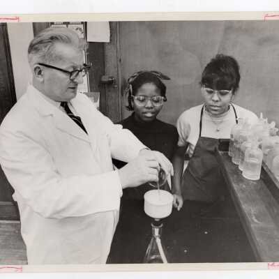 George Beichl, SJC chemistry professor, in science laboratory with several high school students participating in Chemistry Department's Science Motivation Program for high school students, May 1969.