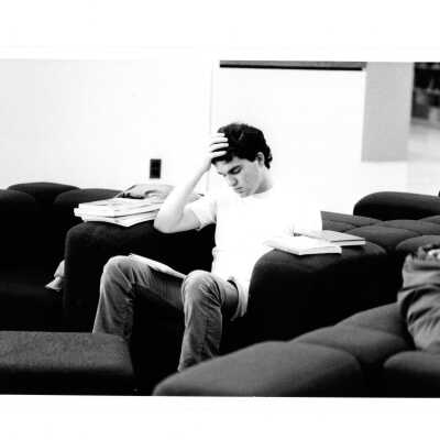 Student sitting in lounge chair and studying in Drexel Library.