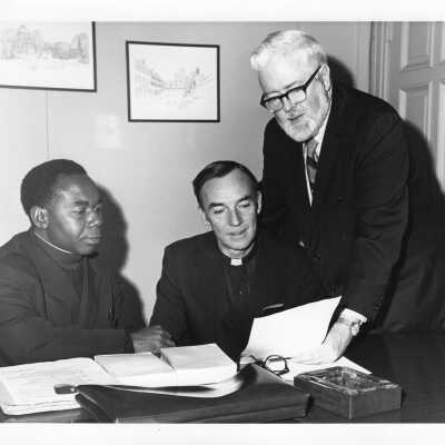 R. P. Mveng, S.J., Director of Cultural Affairs of Federal Republic of Cameroon,with Terrence Toland, S.J., and James E. Dougherty during visit to SJC campus as part of State Department tour, January 31, 1972.