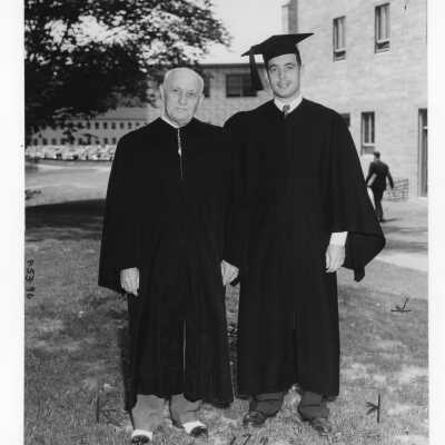 Graduating student Ralph Dungan Jr. with his father, Ralph Dungan, Sr. Class of 1907, at 1950 graduation/commencement ceremony.
