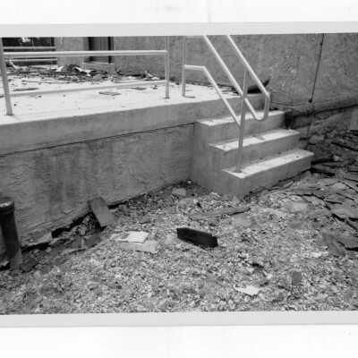 Exterior view of debris on ground outside of Simpson Hall after fire.