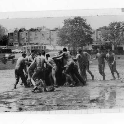 Student in pushball contest in mud during Junior Week activities.