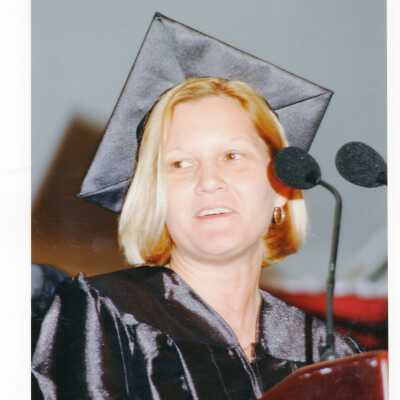 Graduate student, possibly either Pamela Clegg or Jacqui Lorenzo, addressing 1999 graduation/commencement.