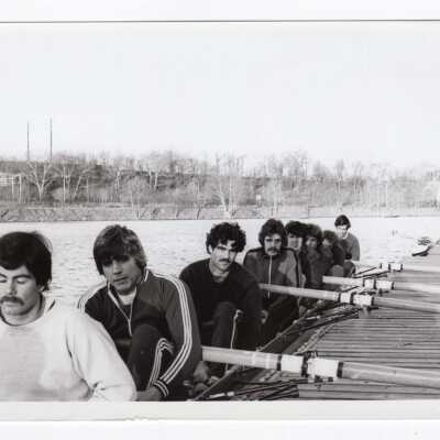 Men's crew/rowing team getting ready to practice at dock on Boathouse Row on Schuylkill River.