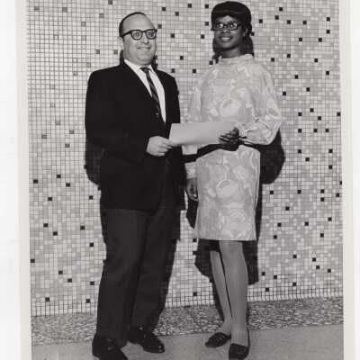 Dominic Roberti awarding certificate of merit to a high school student for participating in Chemistry Department's Science Motivation Program, spring 1968.