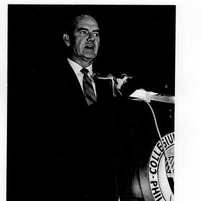 Senator George McGovern delivering speech from podium in Field House, October 2, 1969.