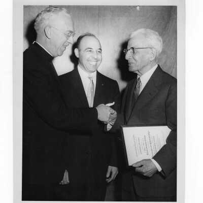 J. Joseph Bluett, S.J., congratulating 1959 Shaffrey award winner, Dr. J. Parsons Schaeffer.
