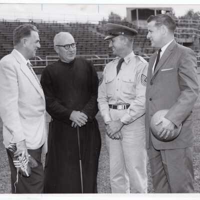 George Bertlesman, Joseph M. Geib, S.J., and Jack Dunn, soccer coach standing on Finnesey Field.