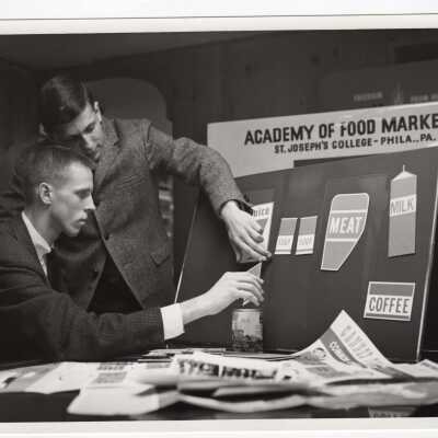 Two students in Academy of Food Marketing preparing a presentation, c. 1965.