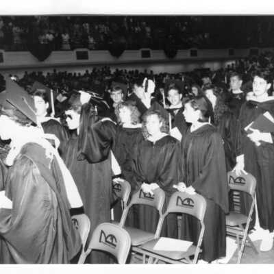 Views of graduates at end of ceremony during 1990 graduation/commencement.