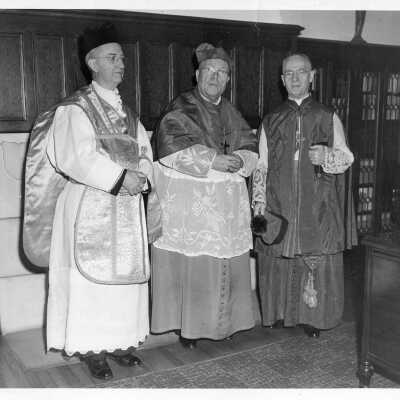 Interior view of Dennis Cardinal Dougherty and two others preparing for dedication of biology laboratory in Barbelin Lonergan building.