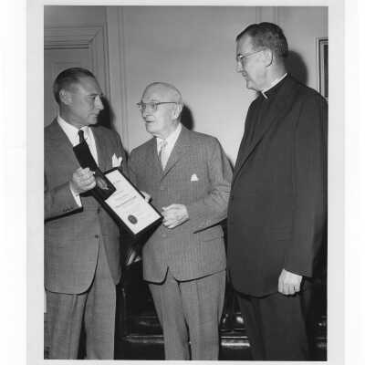 Dr. Brogan showing Shaffrey award and medal to Dr. Truman G. Schnabel, Sr., April 21, 1963 with William F. Maloney, S.J. watching.
