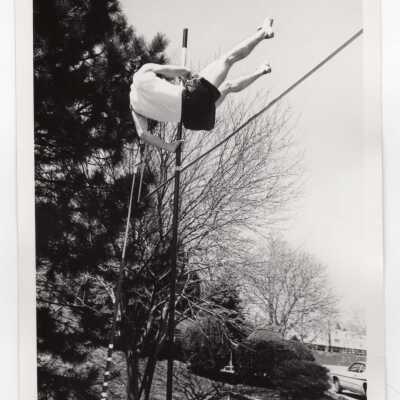 Men's track team member in pole vault event.