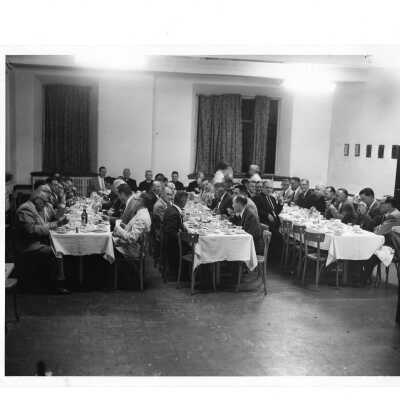 Alumni reunion of class of 1931, held June 1956. View of alumni eating dinner and includes Edward G. Jacklin, S.J., and Joseph S. Hogan, S.J.
