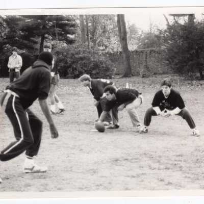 Men playing intramural football game near Gest estate?