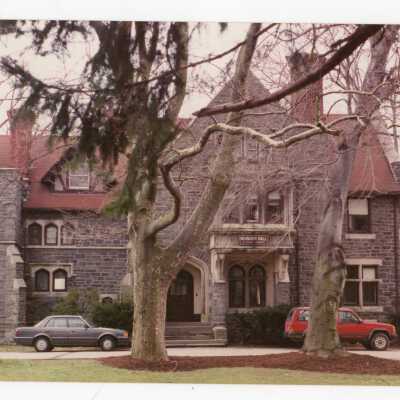 View of front of Wolfington Center (formerly Gest Estate, Neumann Hall) with parked cars.