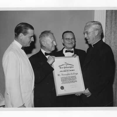 J. Joseph Bluett, S.J., accepting award of merit for Saint Joseph's College from Chamber of Commerce of West Philadelphia, May 5, 1960.