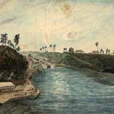 First Eight Locks of the Rideau Canal, the North entrance from the Ottawa River, 1834. Watercolour by Thomas Burrowes (1796–1866): The locks of the Rideau Canal, the Barracks Hill promontory to the right (which would become Parliament Hill) with three stone barracks and a hospital, and John By's, later Major Bolton's, private residence on the opposite hill (the site of the future Major's Hill Park). A wharf and a building occupied by the Royal Engineers is located below the By residence, on the bank of the Ottawa River. The Commissariat is located to the right of the locks (the building still stands and serves as the Bytown Museum). From Archives of Ontario (Ref code C 1-0-0-0-13)