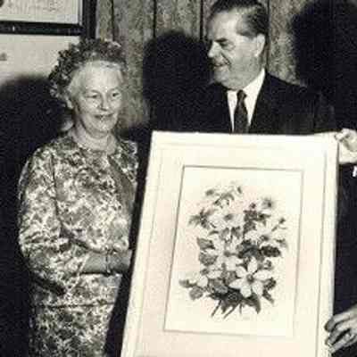 Emily Sartain, artist, ca. 1956: Portrayed with her painting of Pacific dogwood (Cornus nuttallii) which was adopted as B.C.’s floral emblem in 1956. To her left is W.A.C. Bennett PC OC (1900-1979), 25th premier of British Columbia (1952-1972), and the longest-serving premier in B.C. history.