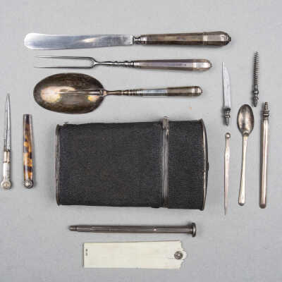 A travelling case with knife, fork, spoon, marrow scoop, corkscrew, snuff-spoon, dividers, rule, ear pick, lancet, gold nibbed pen, and amethyst seal.