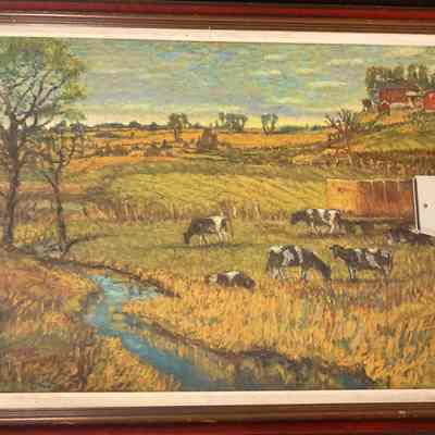 Farm scene with cows and red barns and small creek