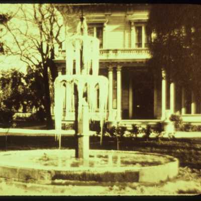 Here you can see the fountain while it stood in front of the Tubbs' family home in the 1880s. This photograph was taken on a rare day, when the water of the fountain froze into icicles.